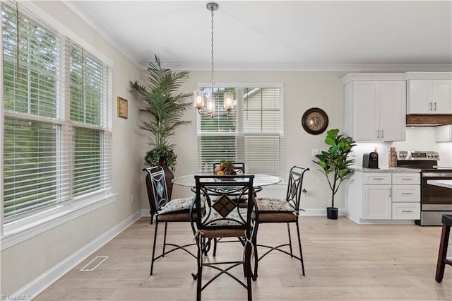 dining space featuring a notable chandelier, crown molding, and a wealth of natural light