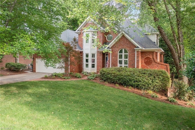 1000 Brookmeade Dr, Winston-Salem, NC 27106 - view of front of home featuring concrete driveway, brick siding, a front lawn, and a garage