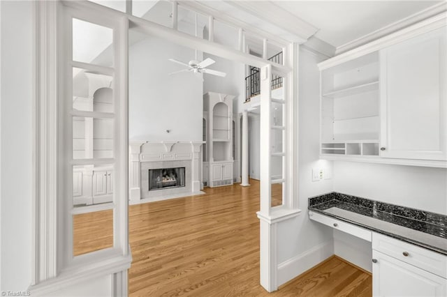 1000 Brookmeade Dr, Winston-Salem, NC 27106 - kitchen featuring light wood finished floors, ceiling fan, white cabinets, a premium fireplace, and open shelves