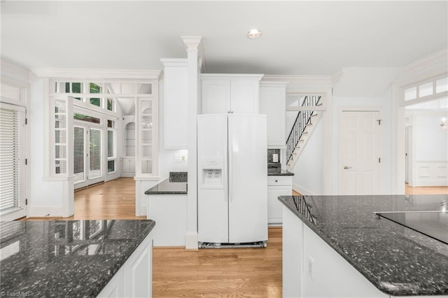 1000 Brookmeade Dr, Winston-Salem, NC 27106 - kitchen with white fridge with ice dispenser, light wood-style flooring, white cabinetry, and plenty of natural light