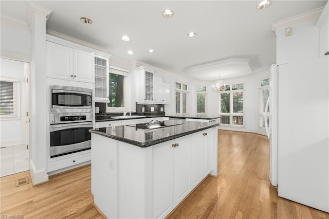1000 Brookmeade Dr, Winston-Salem, NC 27106 - kitchen featuring stainless steel appliances, white cabinetry, a chandelier, ornamental molding, and a kitchen island