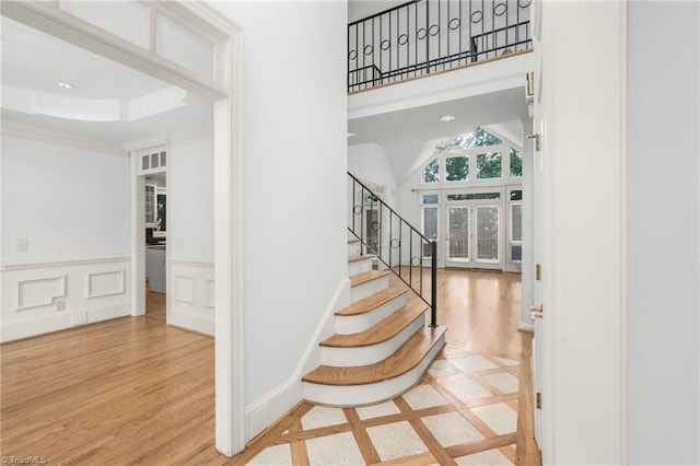 1000 Brookmeade Dr, Winston-Salem, NC 27106 - entrance foyer with wood finished floors, stairway, a wainscoted wall, crown molding, and a towering ceiling