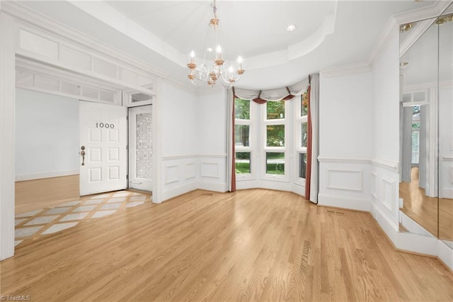 1000 Brookmeade Dr, Winston-Salem, NC 27106 - unfurnished room with a decorative wall, a chandelier, light wood-type flooring, a tray ceiling, and a wainscoted wall