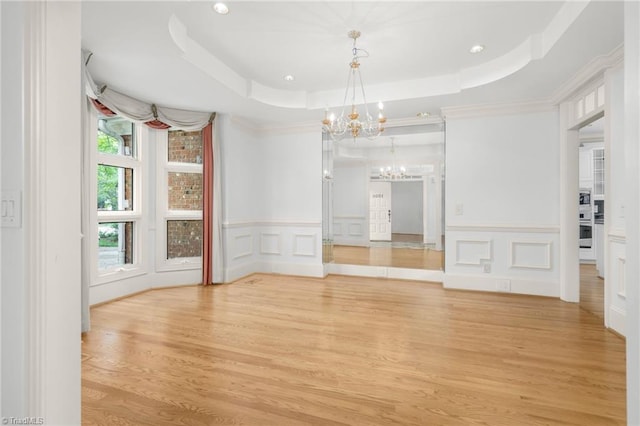 1000 Brookmeade Dr, Winston-Salem, NC 27106 - unfurnished room with a chandelier, a tray ceiling, light wood finished floors, a decorative wall, and recessed lighting