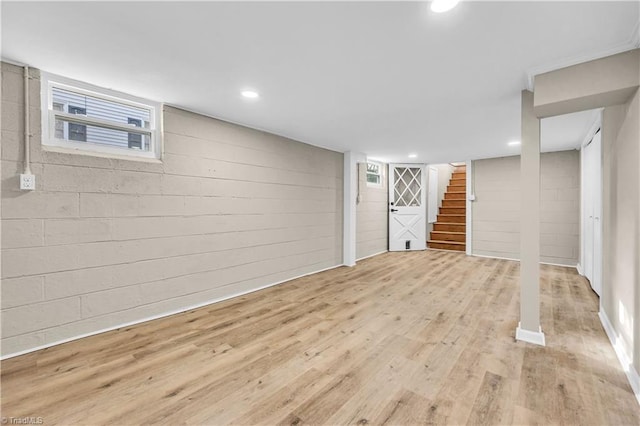 basement with stairs, recessed lighting, and wood finished floors