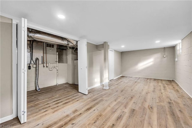 finished basement with visible vents, recessed lighting, and wood finished floors