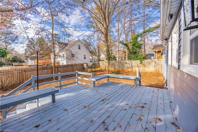 wooden terrace featuring a fenced backyard