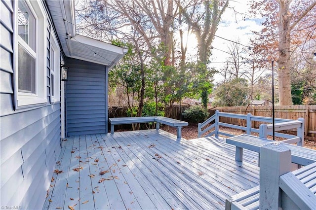 wooden terrace featuring a fenced backyard