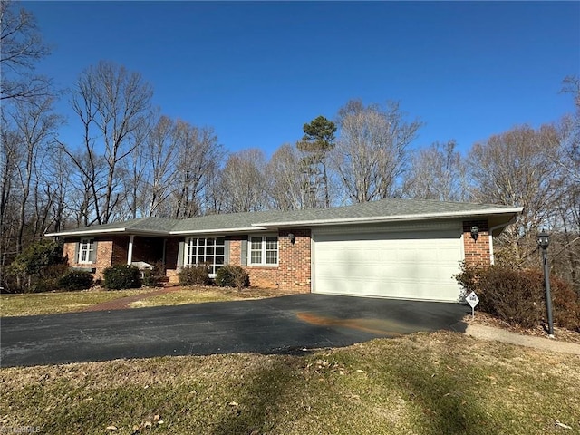 single story home featuring a garage and a front yard