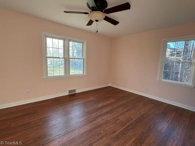 unfurnished room with ceiling fan and dark hardwood / wood-style flooring