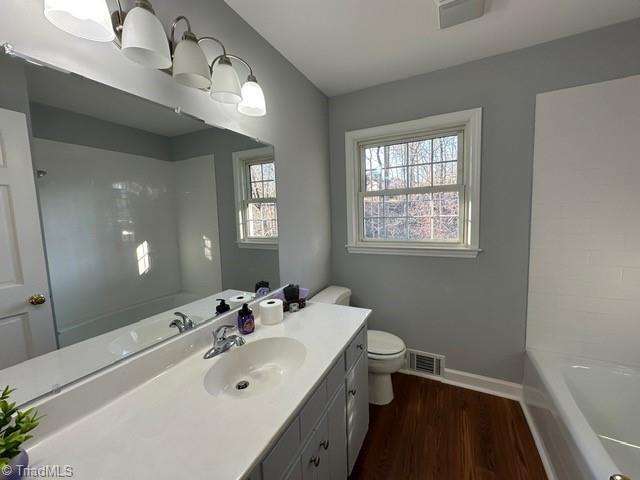 bathroom featuring hardwood / wood-style flooring, vanity, and toilet