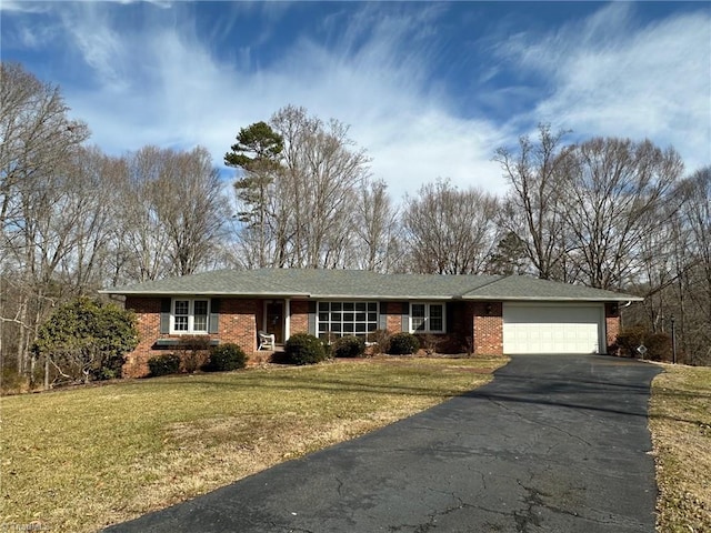 ranch-style house featuring a garage and a front lawn