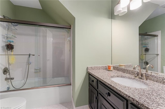 full bathroom with toilet, shower / bath combination with glass door, and vanity