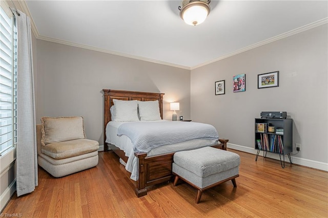 bedroom with baseboards, ornamental molding, and light wood-style floors