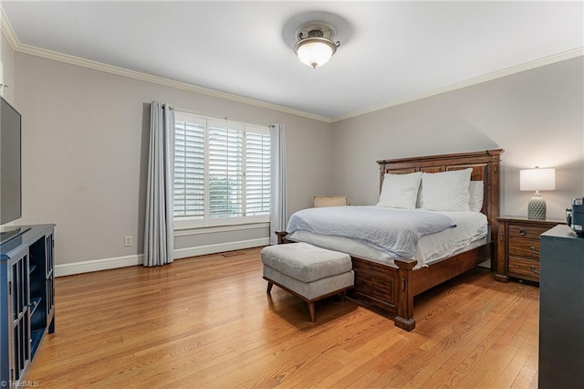 bedroom with baseboards, light wood-style flooring, and crown molding