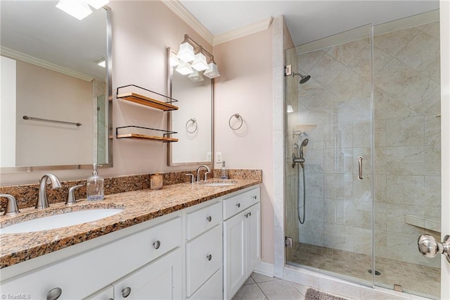 full bath with a shower stall, ornamental molding, and a sink