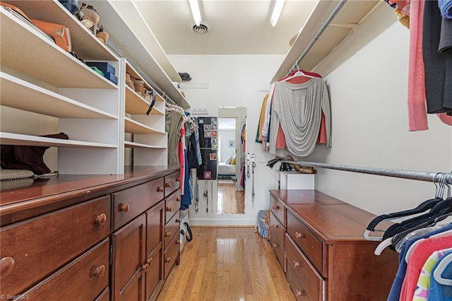 walk in closet with light wood-type flooring and visible vents