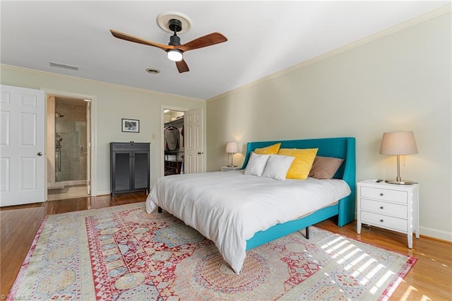 bedroom with baseboards, visible vents, a ceiling fan, wood finished floors, and crown molding