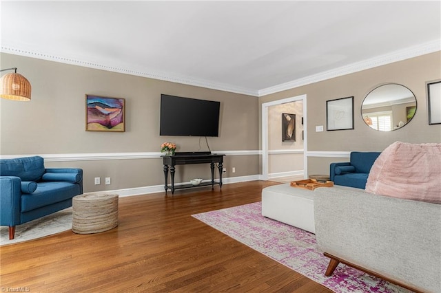 living area with ornamental molding, baseboards, and wood finished floors