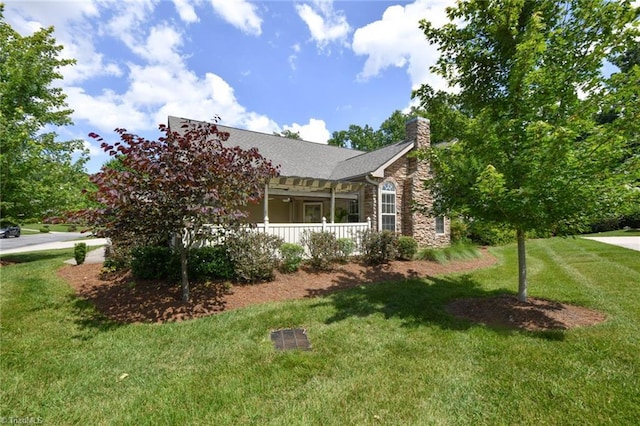 4294 Plantation Ridge Ln, Greensboro, NC 27409 - view of home's exterior featuring stone siding, a lawn, a chimney, and a porch