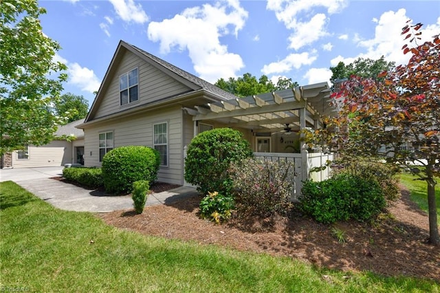 4294 Plantation Ridge Ln, Greensboro, NC 27409 - view of side of property featuring a ceiling fan, a pergola, a yard, and a garage