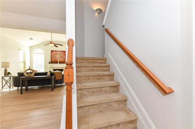 4294 Plantation Ridge Ln, Greensboro, NC 27409 - staircase with wood finished floors, a fireplace, and a ceiling fan