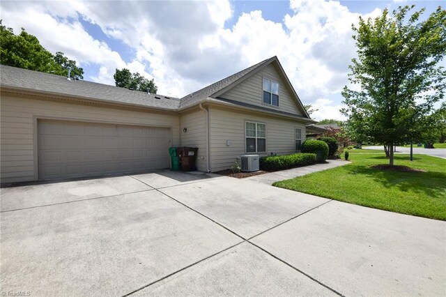 4294 Plantation Ridge Ln, Greensboro, NC 27409 - view of front of house with concrete driveway, a front lawn, and an attached garage