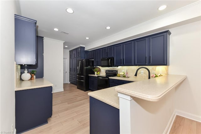 4294 Plantation Ridge Ln, Greensboro, NC 27409 - kitchen featuring black appliances, crown molding, a peninsula, light countertops, and tasteful backsplash