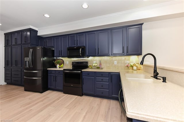 4294 Plantation Ridge Ln, Greensboro, NC 27409 - kitchen with black appliances, ornamental molding, light countertops, blue cabinets, and decorative backsplash