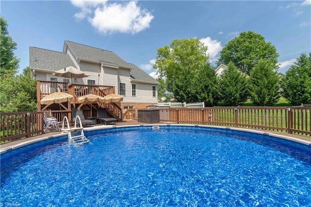 view of swimming pool with stairs, a deck, and a fenced in pool