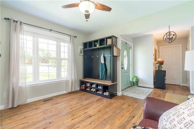 mudroom with a healthy amount of sunlight, baseboards, light wood-type flooring, and visible vents