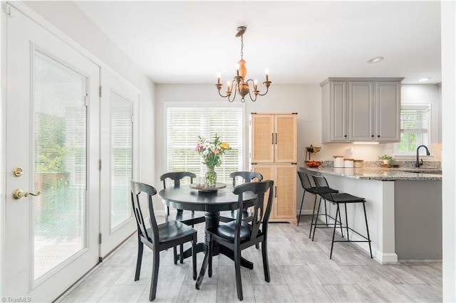 dining space with baseboards, recessed lighting, and a chandelier
