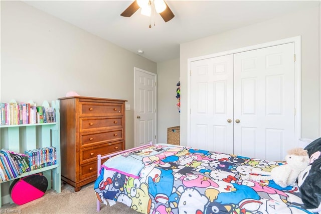 carpeted bedroom featuring ceiling fan and a closet