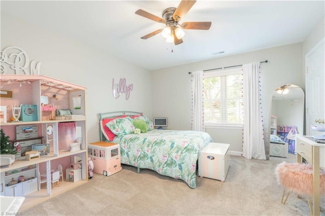 carpeted bedroom with visible vents and a ceiling fan