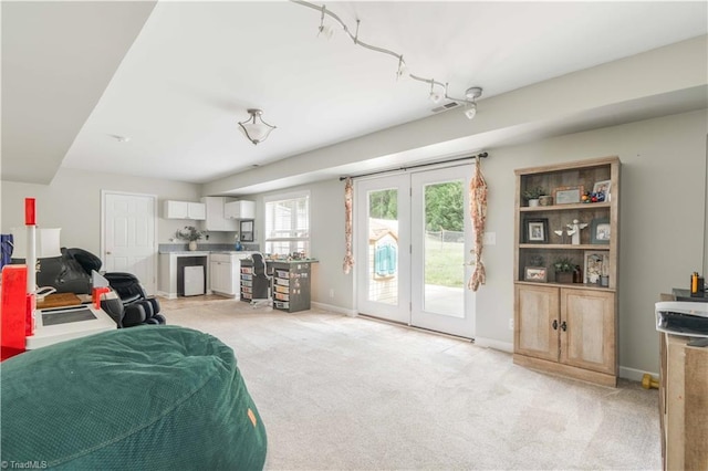 living room featuring baseboards, visible vents, french doors, and light colored carpet