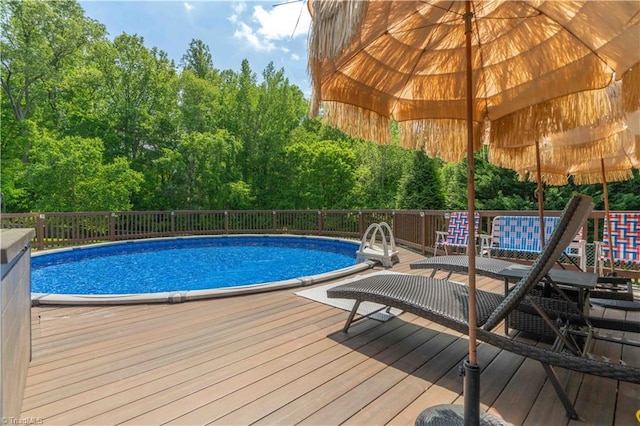view of swimming pool featuring a fenced in pool and a wooden deck