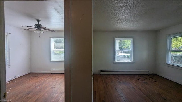 2806 Robin Hood Dr, Greensboro, NC 27408 - spare room featuring a ceiling fan, wood-type flooring, a baseboard heating unit, baseboards, and baseboard heating