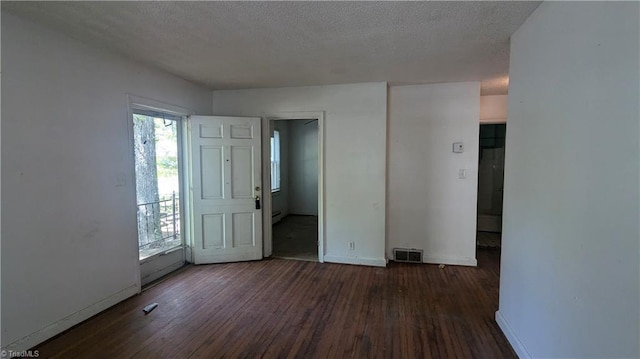 2806 Robin Hood Dr, Greensboro, NC 27408 - unfurnished room featuring wood-type flooring, baseboards, a healthy amount of sunlight, and visible vents
