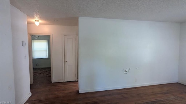 2806 Robin Hood Dr, Greensboro, NC 27408 - unfurnished room with baseboards, wood finished floors, and a textured ceiling