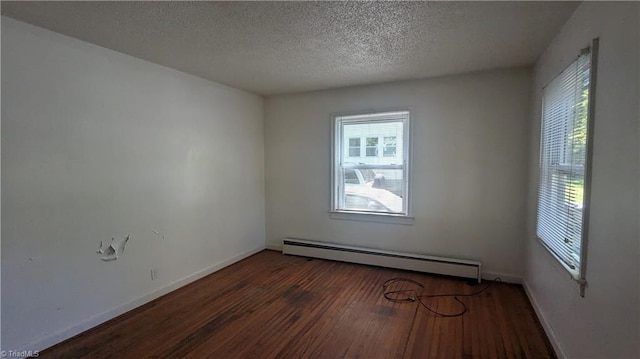 2806 Robin Hood Dr, Greensboro, NC 27408 - empty room featuring a baseboard heating unit, baseboards, wood finished floors, and a textured ceiling