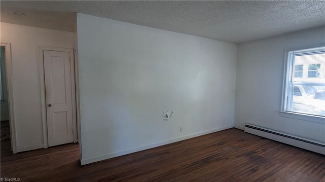 2806 Robin Hood Dr, Greensboro, NC 27408 - empty room featuring a baseboard radiator, baseboards, wood finished floors, and a textured ceiling