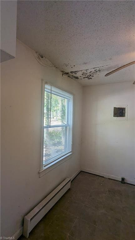 2806 Robin Hood Dr, Greensboro, NC 27408 - empty room with baseboard heating and a textured ceiling