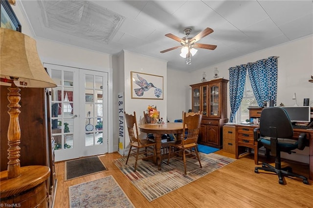 dining room featuring ceiling fan, light hardwood / wood-style flooring, and french doors