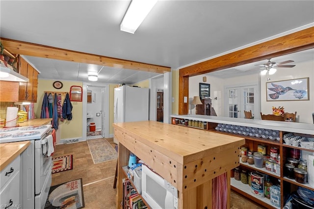 kitchen featuring white appliances, ceiling fan, and butcher block counters