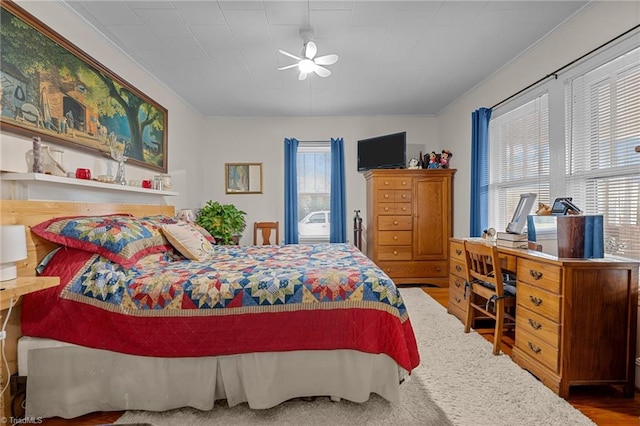 bedroom with hardwood / wood-style flooring and ceiling fan