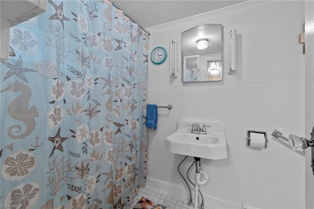 bathroom featuring tile patterned floors, ornamental molding, tile walls, and walk in shower