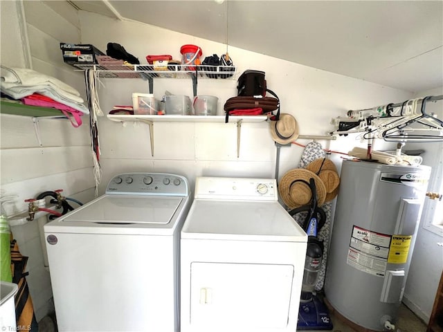 clothes washing area featuring water heater and independent washer and dryer