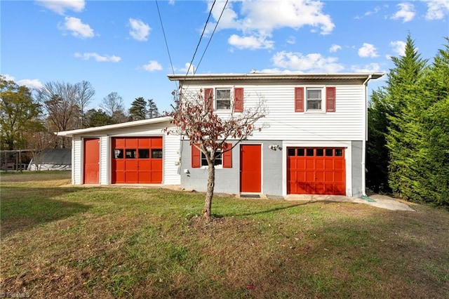 view of front of home with a front yard and a garage