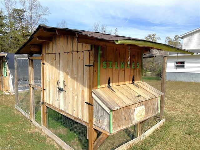 view of outbuilding with a lawn