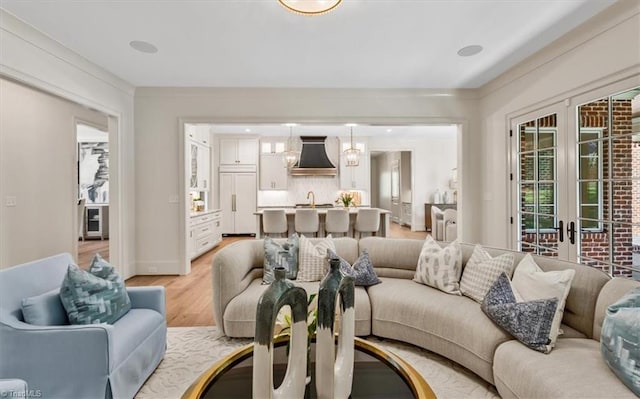 905 Brookside Dr, Greensboro, NC 27408 - living room featuring light wood-style flooring, baseboards, and french doors